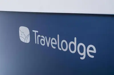 a sign for a travel loadage company on a wall at Travelodge Ipswich in Ipswich