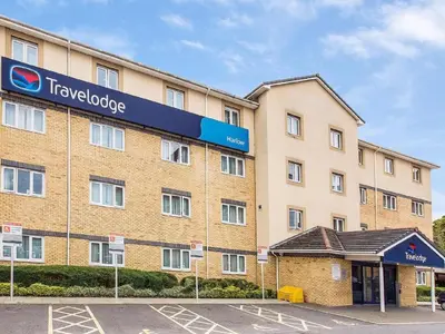 a large building with a sign on the side of it at Travelodge Harlow in Harlow