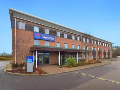 a large brick building with a trucking sign on it at Travelodge Haverhill in Haverhill