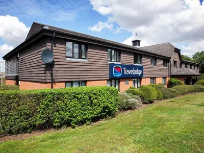 a building with a sign on the side of it at Travelodge Ipswich Beacon Hill in Needham Market