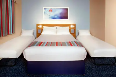 a pair of beds in a hotel room at Travelodge Ipswich Beacon Hill in Needham Market