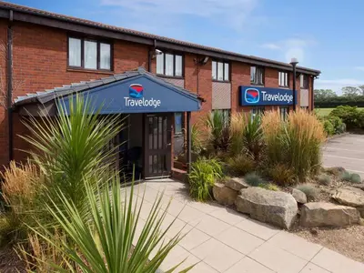 a building with a sign on the front of it at Travelodge Cambridge Swavesey in Bar Hill