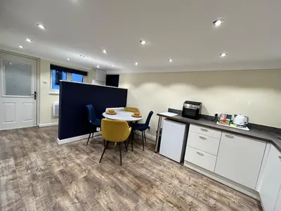 an office with a kitchen and a table and chairs at The old greengrocers Battlesbridge in Rawreth