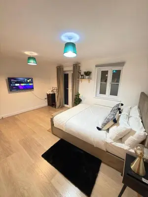 a bedroom with a bed and a couch and a tv at Oak House No15 Scotland Road 5BR Parking in Chesterton