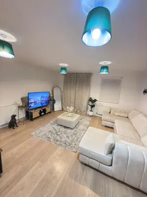 a living room with white furniture and a flat screen tv at Oak House No15 Scotland Road 5BR Parking in Chesterton