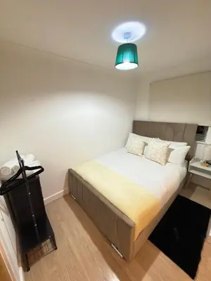 a bedroom with a bed with a green light at Oak House No15 Scotland Road 5BR Parking in Chesterton
