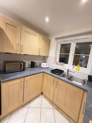 a kitchen with wooden cabinets and a sink at Oak House No15 Scotland Road 5BR Parking in Chesterton