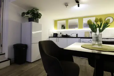 a kitchen with a table with a vase of flowers at Central Location Stylish 1-Bed Apartment Free Parking in Colchester