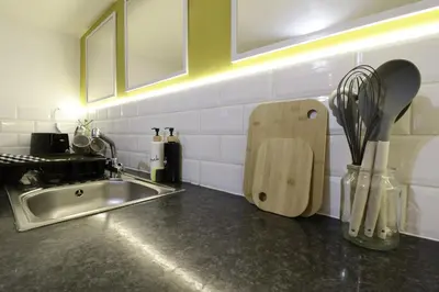 a kitchen counter with a sink and a knife block at Central Location Stylish 1-Bed Apartment Free Parking in Colchester