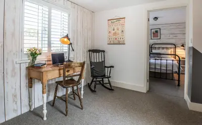 a home office with a desk and a bed at Blackshore House in Wenhaston
