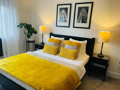 a bedroom with a bed with a yellow blanket at Cozy Organic Tea House in Central Ipswich near Waterfront, University and Hospital in Ipswich