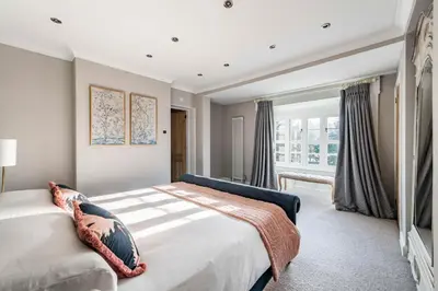 a bedroom with a large bed and a window at Bressingham Lodge by Leap Escapes in Diss