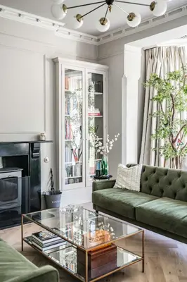 a living room with a green couch and a glass coffee table at Bressingham Lodge by Leap Escapes in Diss