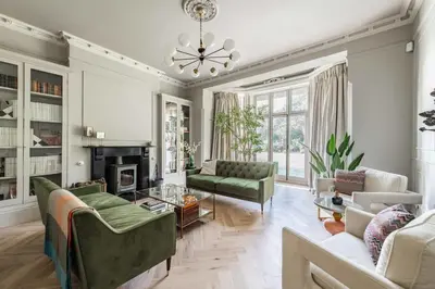 a living room with a couch and a fireplace at Bressingham Lodge by Leap Escapes in Diss