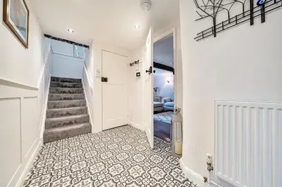 a hallway with a staircase and a stairwayexit sidx sidx sidx at Old Rectory Cottage, Tostock in Tostock