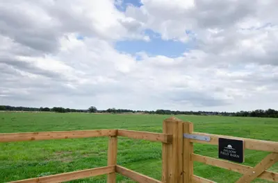 a wooden fence in a field with a sign on it at 2 Bed in Newton oc-ffba in Newton