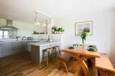 a kitchen with a wooden table and a dining room at 2 Bed in Newton oc-ffba in Newton