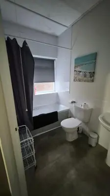 a bathroom with a toilet and a tub and a sink at Happy house in Southend-on-Sea