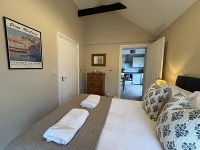a bedroom with a bed with two towels on it at Well-Connected One Bedroom Self-Contained Rural Retreat in Chelmsford