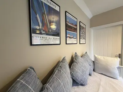 a bedroom with a bed with pillows and posters on the wall at Well-Connected One Bedroom Self-Contained Rural Retreat in Chelmsford