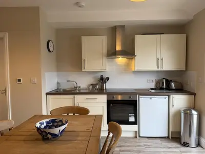 a kitchen with a wooden table with a bowl on it at Well-Connected One Bedroom Self-Contained Rural Retreat in Chelmsford