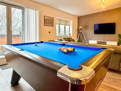a living room with a pool table in a room at Split level unique large 2BDR apartment in Chelmsford
