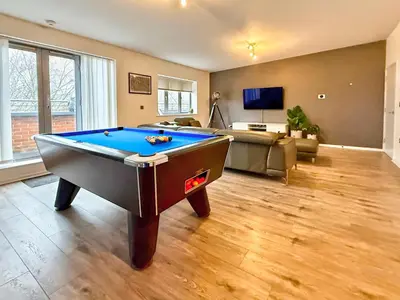 a living room with a pool table in it at Split level unique large 2BDR apartment in Chelmsford