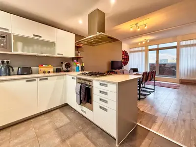 a kitchen with white cabinets and a stove top oven at Split level unique large 2BDR apartment in Chelmsford
