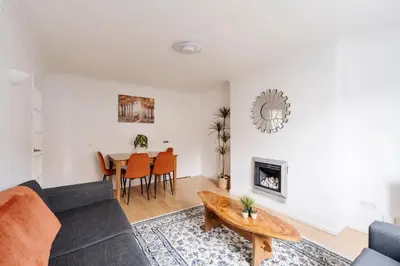 a living room with a couch and a table at La Casa Bianca in Bury Saint Edmunds