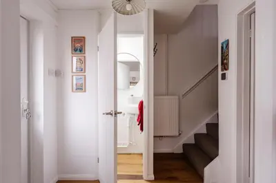 a hallway with a white door and a stairway at La Casa Bianca in Bury Saint Edmunds