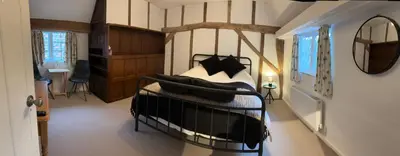 a bedroom with a bed in a room with a mirror at 7 The Quay in St Ives