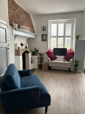 a living room with a couch and a chair at 7 The Quay in St Ives