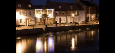 a city with buildings and a river at night at 7 The Quay in St Ives