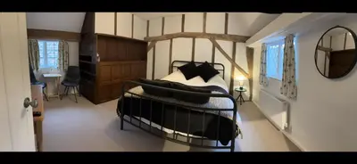 a bedroom with a bed with black and white pillows at 7 The Quay in St Ives