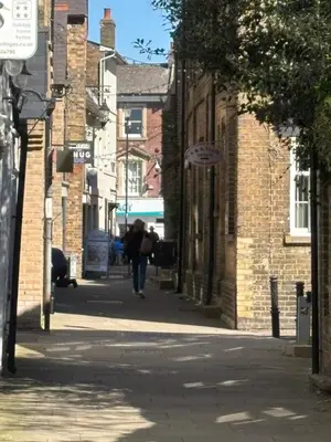 a person walking down a street in an alley at 7 The Quay in St Ives