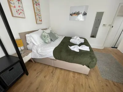 a bedroom with a bed with towels on it at Queens - Cosy Central Apartment - JTAP Properties in Cambridge