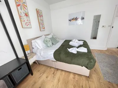 a bedroom with a bed with two towels on it at Queens - Cosy Central Apartment - JTAP Properties in Cambridge