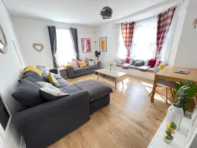 a living room with a couch and a table at Queens - Cosy Central Apartment - JTAP Properties in Cambridge