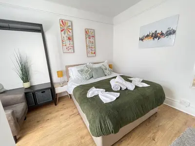 a bedroom with a bed with two white towels on it at Queens - Cosy Central Apartment - JTAP Properties in Cambridge