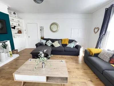 a living room with a couch and a table at Queens - Cosy Central Apartment - JTAP Properties in Cambridge