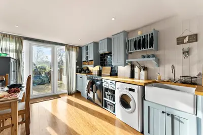 a kitchen with a washer and dryer at Abbey House- Character filled 1 bed- sleeps 4 in Bury Saint Edmunds