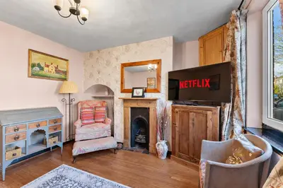 a living room with a tv and a fireplace at Abbey House- Character filled 1 bed- sleeps 4 in Bury Saint Edmunds