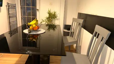 a table with a bowl of fruit on top of it at Cozy Guest Room in Basildon with Shared Facilities in Basildon