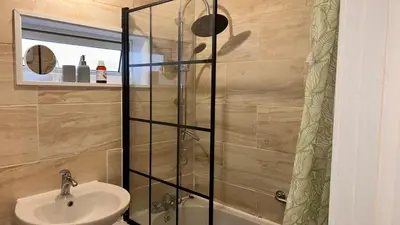 a bathroom with a sink and a shower at Cozy Guest Room in Basildon with Shared Facilities in Basildon