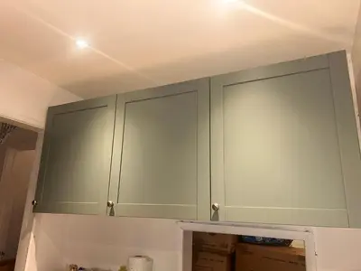a green cabinet in a room with boxes at Charming Essex Guest Room Comfort, Convenience, and Countryside Charm in Basildon