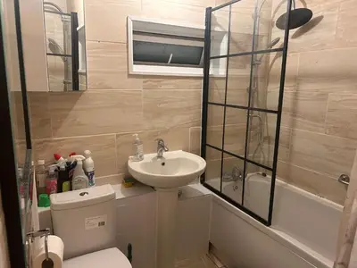 a bathroom with a sink and a toilet and a shower at Charming Essex Guest Room Comfort, Convenience, and Countryside Charm in Basildon