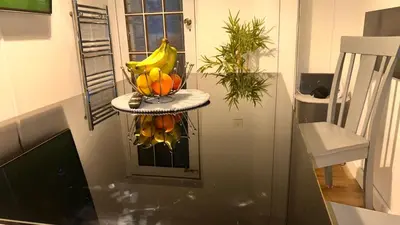 a bowl of bananas and oranges on a shelf in a kitchen at Charming Essex Guest Room Comfort, Convenience, and Countryside Charm in Basildon
