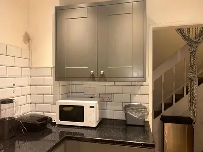 a kitchen with a microwave on a counter at Charming Essex Guest Room Comfort, Convenience, and Countryside Charm in Basildon