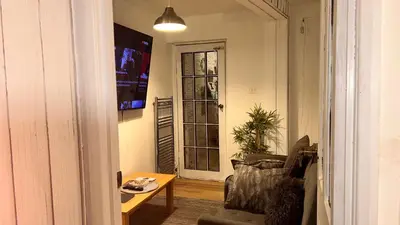 a living room with a chair and a table and a window at Serene Guest Retreat in Basildon Comfort and Convenience Await in Basildon