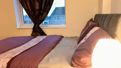 a bed in a room with a window at Serene Guest Retreat in Basildon Comfort and Convenience Await in Basildon